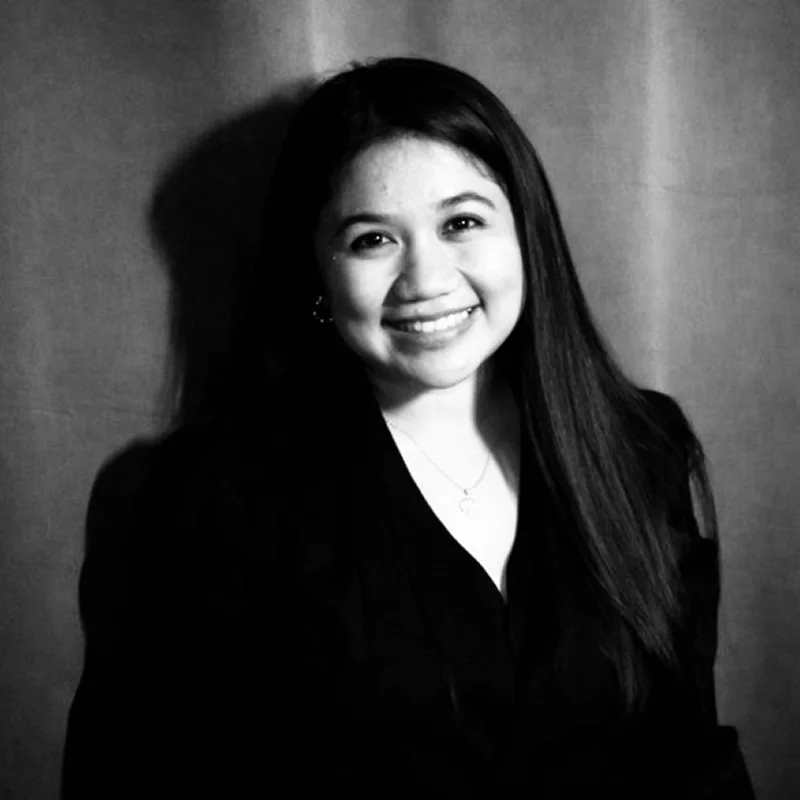 Black-and-white portrait of smiling young woman