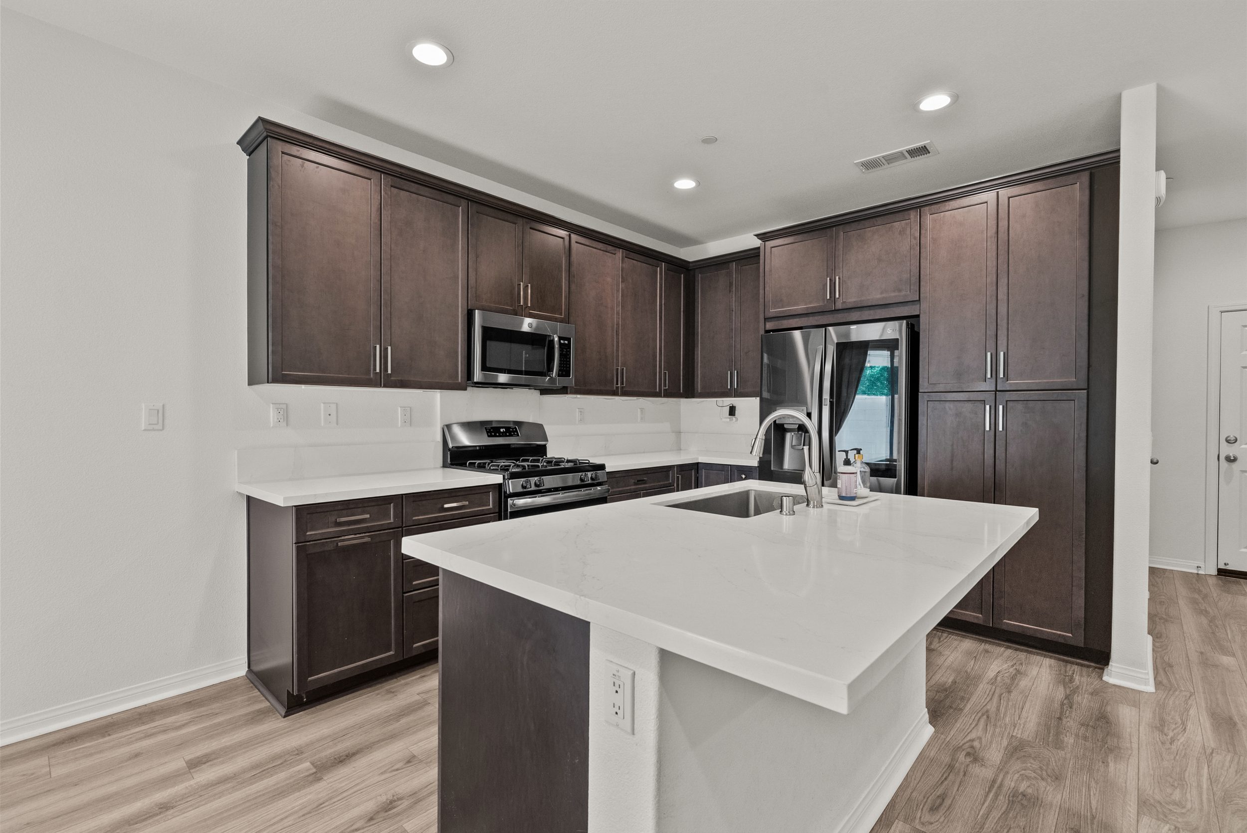 Modern kitchen with island and stainless appliances