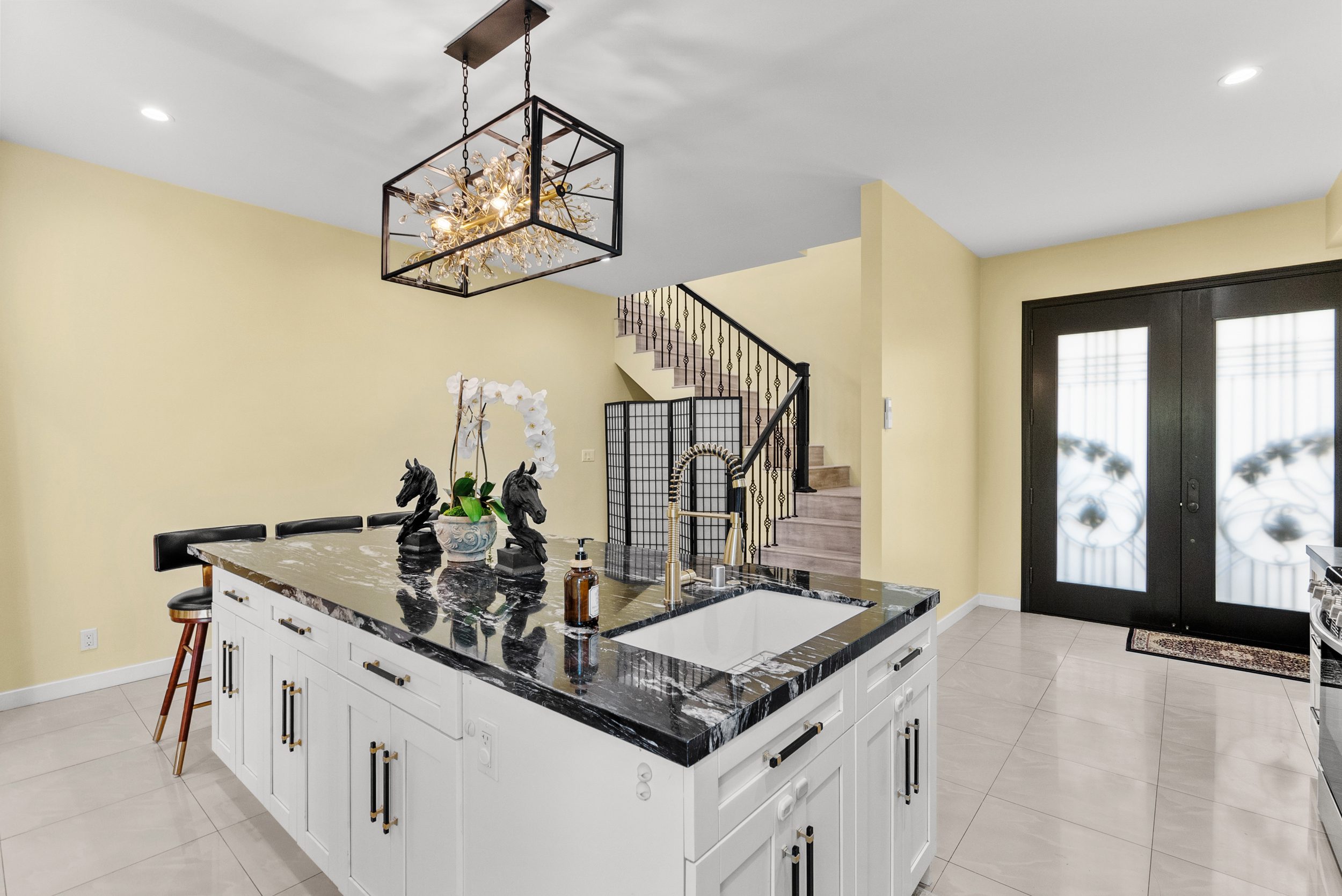 Modern kitchen island with black marble countertop